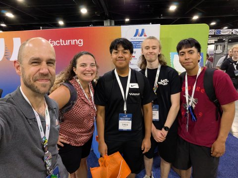 Photo of student visitors at the Manufacturing USA booth at Skills USA