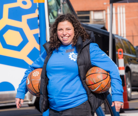 Photo of Jennie Becker smiling holding basketballs