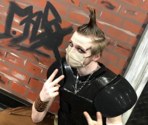 Photo of Maddox Fooks with his hair in a mohawk wearing a face mask.