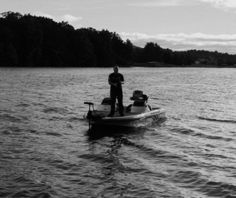 Photo of David Roberson on a boat on a lake bass fishing