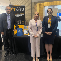 Photo of ARM Institute staff in front of their table at the PA AI Energy Summit